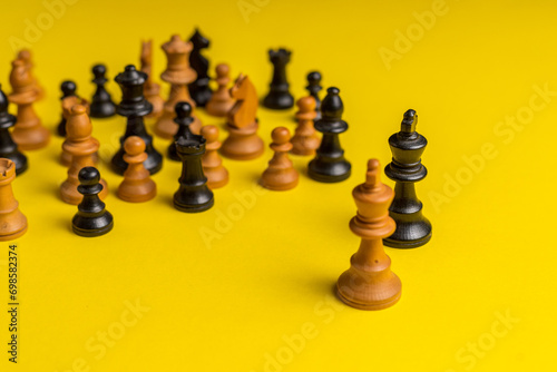 black and white chess pieces on yellow background, racism concept