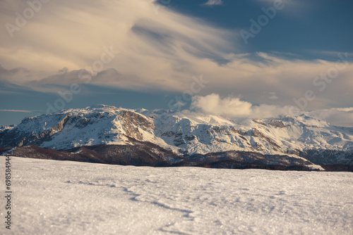 Pristine snow blankets rugged terrain. © fluidni