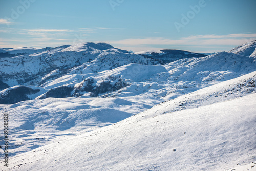 Pristine snow blankets rugged terrain.