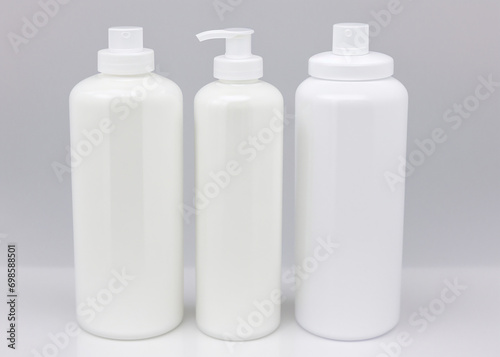 A group of white bottles, cosmetics, soap, cream. 