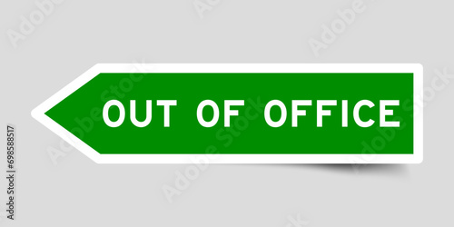 Green color arrow shape sticker label with word out of office on gray background