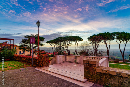 Evening city landscape of the belvedere square of Castagneto Carducci in the background the sea and the Tuscan Italy countryside photo