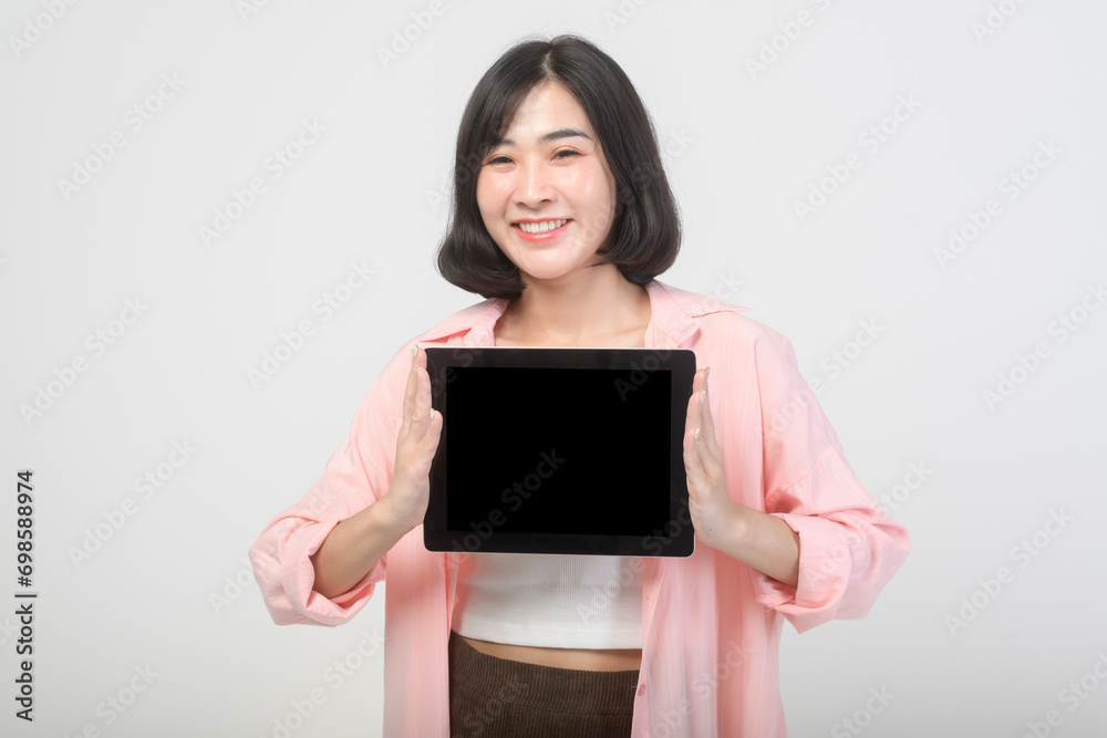 Young asian woman using tablet over white background, technology concept