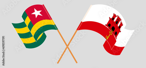 Crossed and waving flags of Togo and Gibraltar