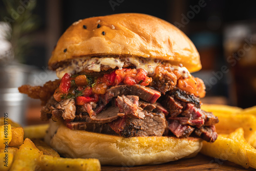 Brisket sandwich with sweet pepper, caramelized onion and aioli sauce served with a portion of French fries
