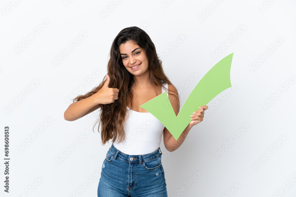 Young caucasian woman isolated on white background holding a check icon with thumb up Young caucasian woman isolated on white background holding a check icon with thumb up