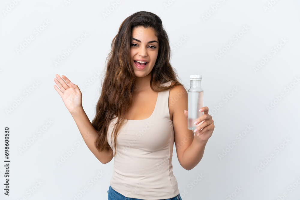 Young caucasian woman with a bottle of water isolated on white background saluting with hand with happy expression Young caucasian woman with a bottle of water isolated on white background saluting with hand with happy expression