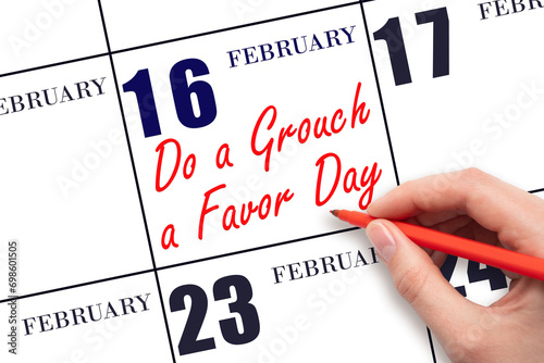 February 16. Hand writing text Do a Grouch a Favor Day on calendar date. Save the date. photo