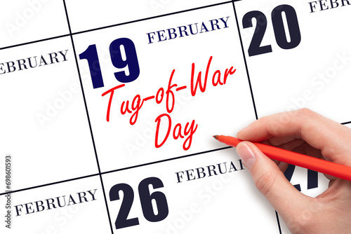 February 19. Hand writing text Tug-of-War Day on calendar date. Save the date.