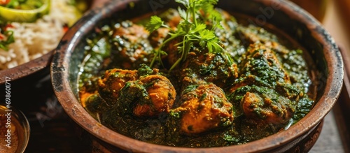 Hyderabad's chicken Hariyali with coriander, served with palak spinach. photo