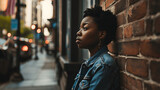 Young black woman gazing and thinking in urban city environment