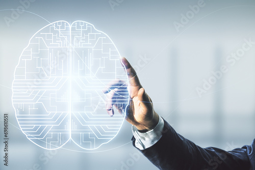 Man hand working with virtual creative artificial Intelligence hologram with human brain sketch on blurred office background. Multiexposure