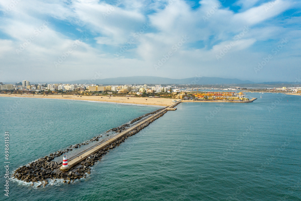Aerial view of famous Portuguese city Portimao. View of beautiful La Rocha Beach at left, Portimao Marina in right side. European travel destination. Panoramic view of all region.