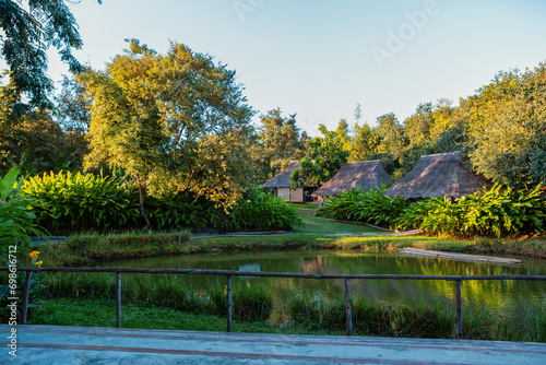 Cottage for living next to the pond on a clear day photo