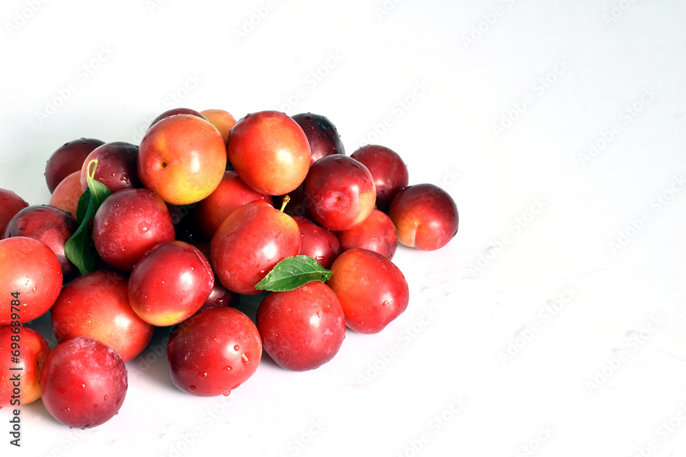 Harvest in the form of a slide of ripe plums on a white background. Harvest in the form of a slide of ripe plums on a white background.