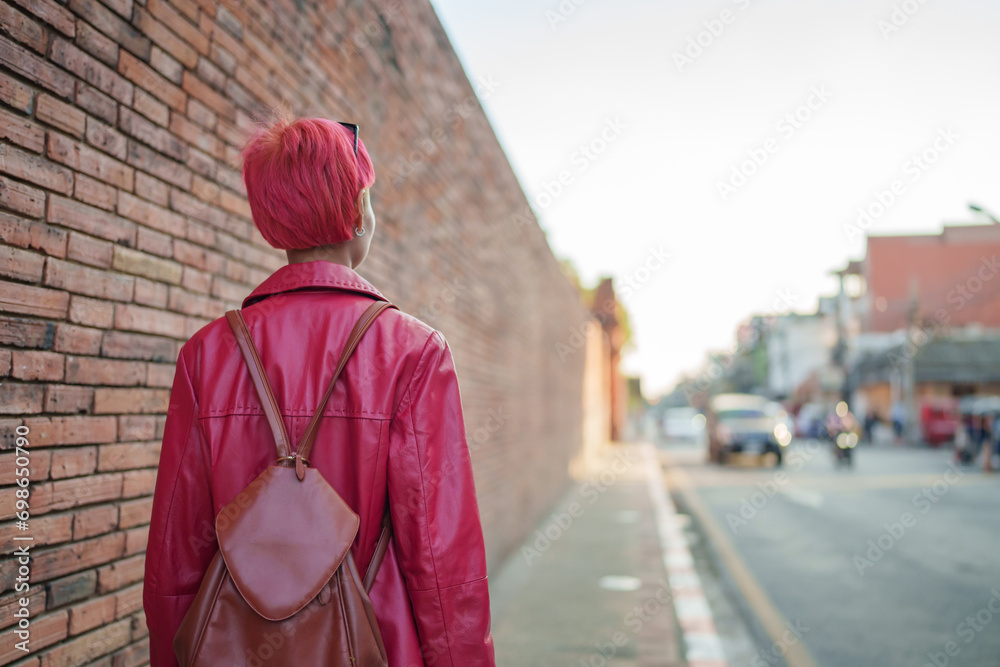 Gen z girl leather fashion with punk Asian woman tourist of local city Southeast Asia travel trendy pink hairstyle young female punk traveler walking around in town Gen z girl leather fashion with punk Asian woman tourist of local city Southeast Asia travel trendy pink hairstyle young female punk traveler walking around in town