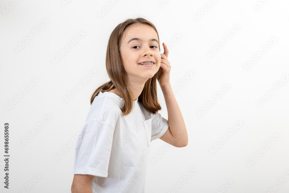 Caucasian teenage girl smiling on a white background isolated. Caucasian teenage girl smiling on a white background isolated.