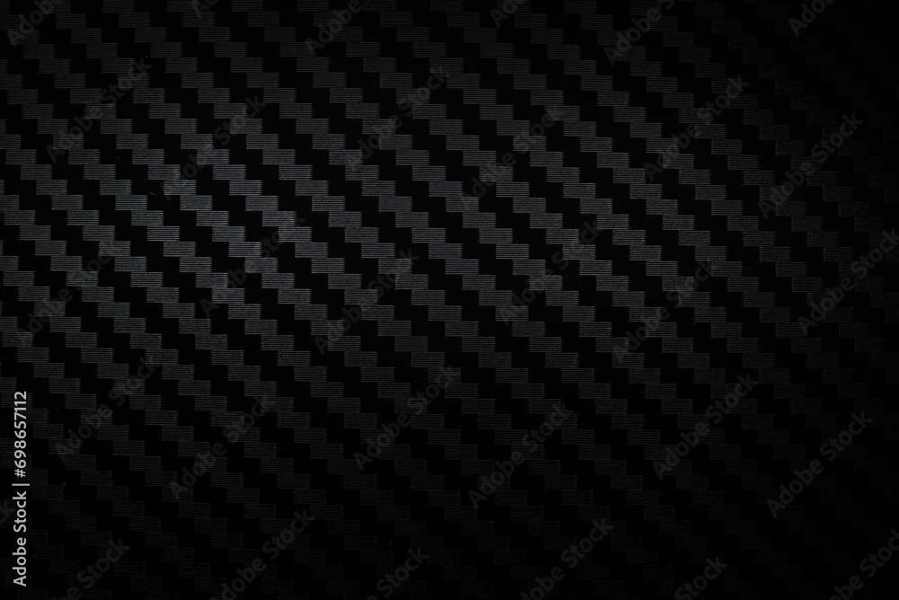 Carbon fiber composite raw material background. Carbon fiber texture. Dark Gray background with lighting. - obrazy, fototapety, plakaty 