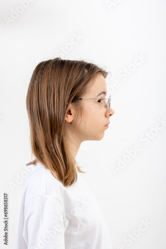 Side view portrait of girl with glasses, isolated on white background.