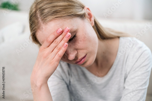 upset woman touching her forehead and thinking about problems