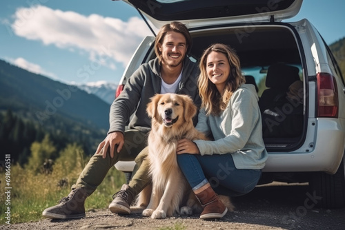 Young beautiful couple with dog traveling by car in the mountains, summer vacation and adventure