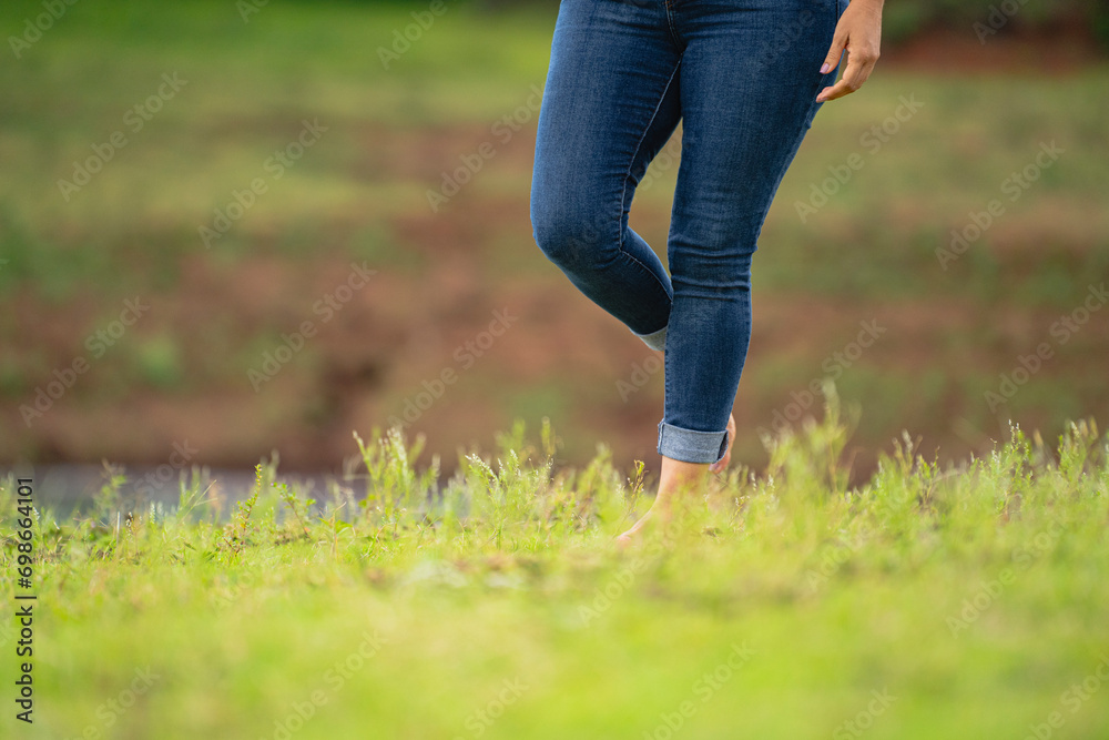 Fototapeta premium person walking on the grass