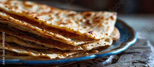 Layered flatbread, made with maida or whole wheat flour, commonly eaten during breakfast with spicy Asian curry gravy. Popular Indian dish. photo