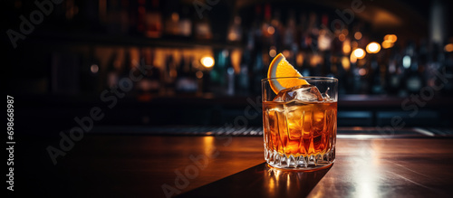 an old fashioned glass of whiskey sitting on and old fashioned wooden bar photo