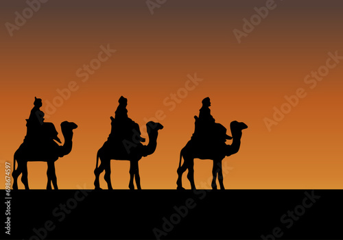  Silueta de reyes magos montados en camello en el atardecer.  photo
