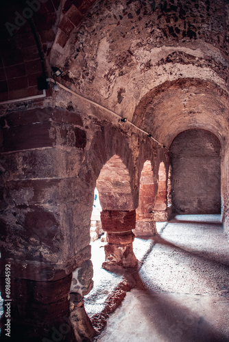 Columns of ancient fortified defense tower photo. Historical center of old medieval town, Catalonia