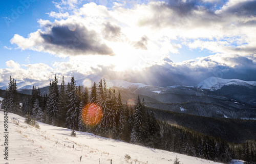 the sun blinds among the sparkling snows high in the mountains in spring photo