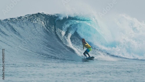 Beginner surfer rides big wave in the Maldives photo