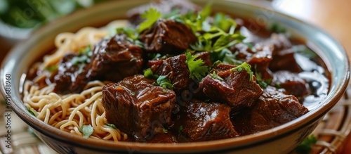 Freshly cooked Filipino Beef Pares Mami, a photo of tender beef cubes with noodles. photo