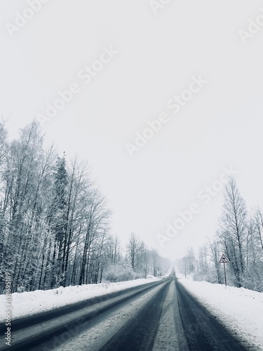 Empty snowy asphalt road, winter