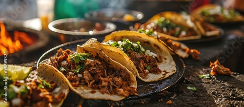 In northern Mexico, roast meat tacos with Chorizo are a popular dish that is cooked by exposing food to heat from embers, known as Carne Asada, Asado, Discada, or Parrillada. photo