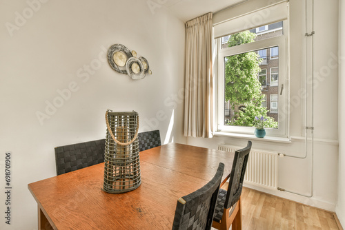 Dining room with wooden table and window photo