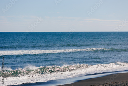 Landscape of Khalaktyrsky beach with black volcanic sand coast of North Pacific Ocean Kamchatka Russia photo