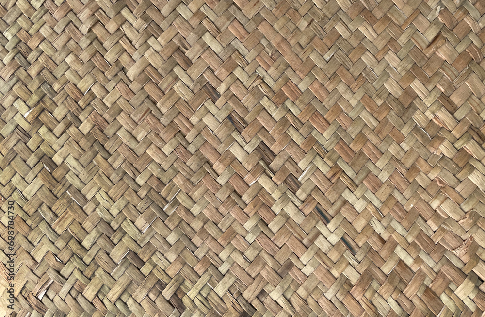 Woven wood pattern or background. Textured of the rattan basket. Background and texture with brown wicker rattan. Woven wood pattern or background. Textured of the rattan basket. Background and texture with brown wicker rattan.