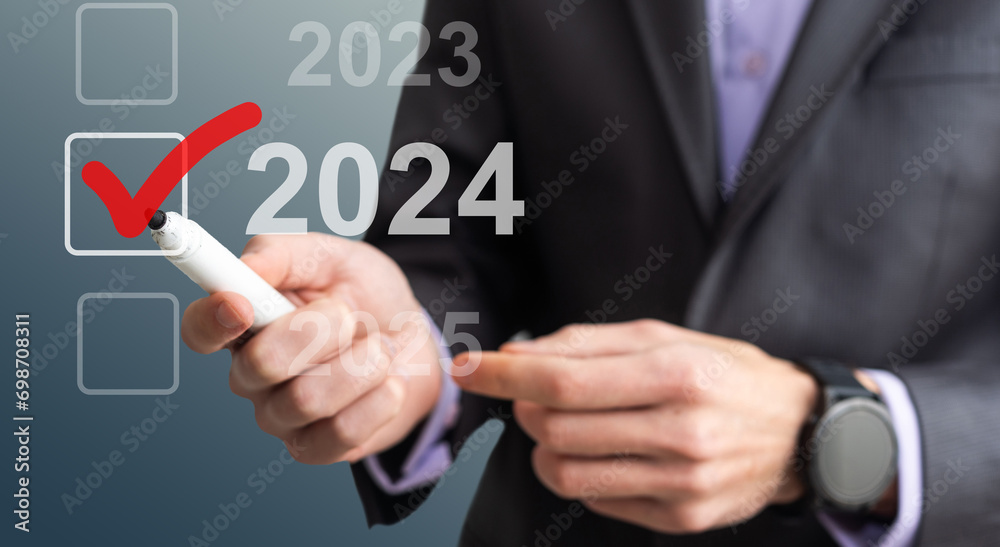 man hand touching on 2024 calender year button on digital virtual screen blur background man hand touching on 2024 calender year button on digital virtual screen blur background