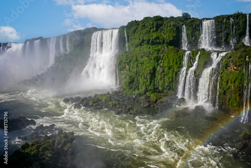 Water cascading over the Iguacu falls with rainbow in Brazil © Nigel