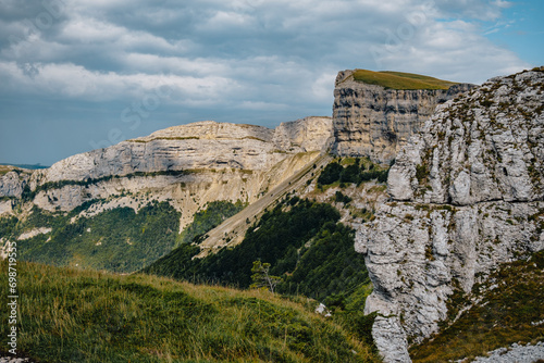 View of the alpine meadows of the Font d Urle plateau in the Vercors  Dr  me  France  with its cliffs  limestone rocks  and pastures