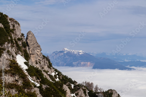 Scenic view of mountain peak Schwarzkogel and Dobratsch in Karawanks mountains in Carinthia, Austria. Magical atmosphere in remote landscape in Slovenian Austrian Alps. Misty fog and clouds in valley © Chris