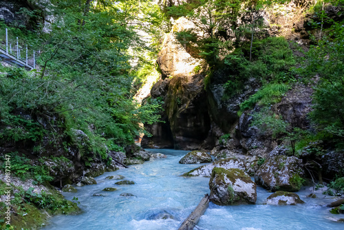 Scenic view of river Loiblbach in Tscheppaschlucht gorge in Carinthia, Austria. Narrow canyon in middle of dense forest. Stream is crystal clear and turquoise colored. Cascading water in wilderness photo