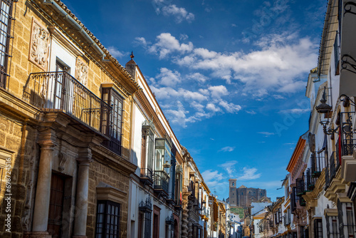 Spectacular and historic Seville street in Osuna, Seville, Andalusia, Spain, with the collegiate church in the background on a hill photo