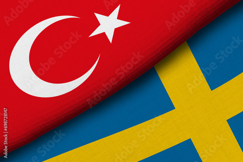 Two flags of Republic of Turkey and Sweeden together with fabric texture, bilateral relations, peace and conflict between countries, great for background photo