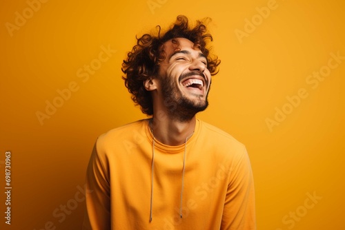 portrait of a happy person isolated on a yellow background 