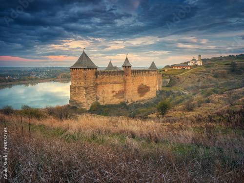 dark clouds  and sunset light above old fortress in Ukraine
