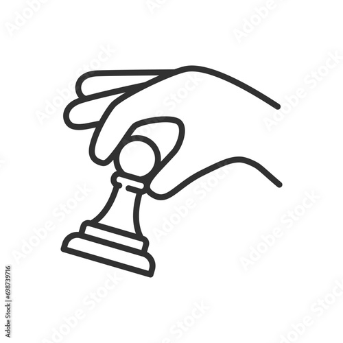A hand places a pawn, linear icon. Game of chess. Line with editable stroke
