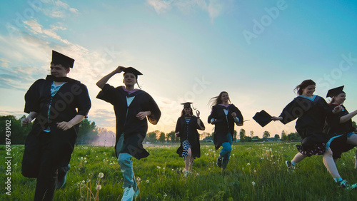 College graduates run at sunset in the evening.