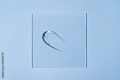 Clear cosmetic gel drop placed in a piece of glass photo